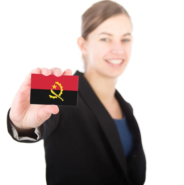 Business woman holding a card with the flag of Angola — Stock Photo, Image