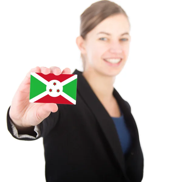 Business woman holding a card with the flag of Burundi — Stock Photo, Image