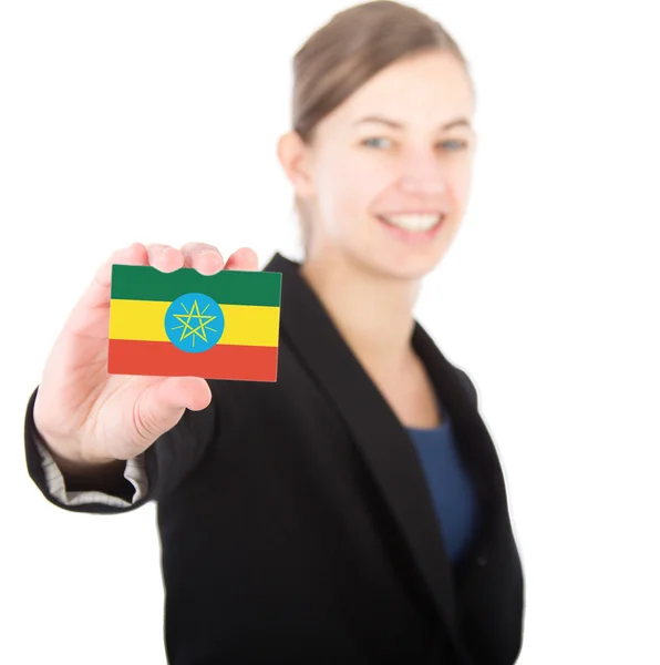 Business woman holding a card with the flag of Ethiopia — Stock Photo, Image