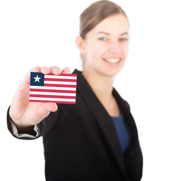 Mujer de negocios sosteniendo una tarjeta con la bandera de Liberia — Foto de Stock