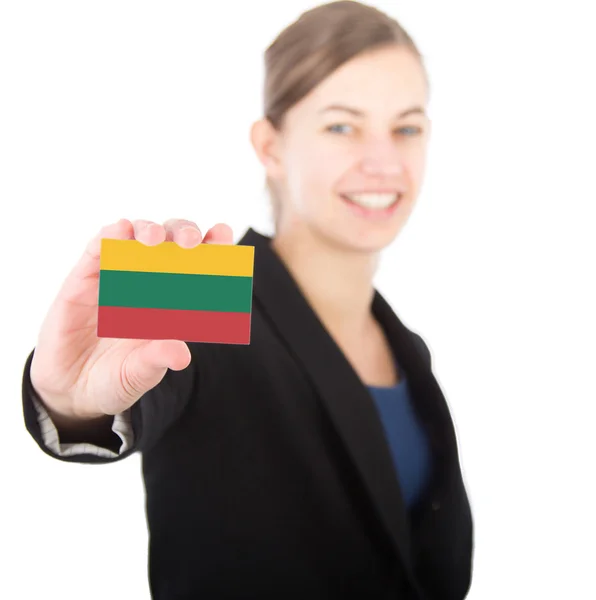 Business woman holding a card with the flag of Lithuania — Stock Photo, Image