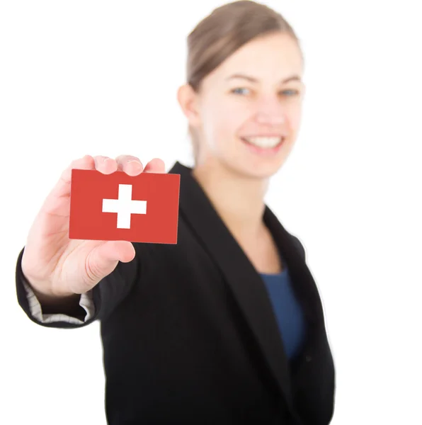 Business woman holding a card with the flag of Switzerland — Stock Photo, Image