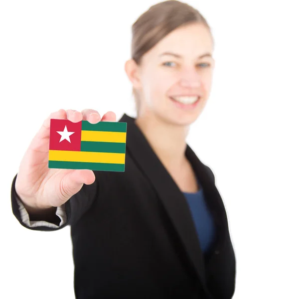 Business woman holding a card with the flag of togo — Stock Photo, Image