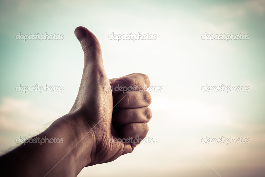 Hand with thumb up.