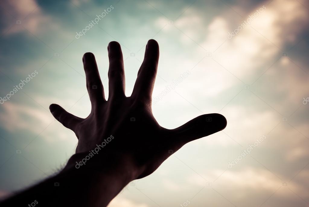 Hand of a man reaching to sky.