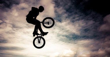 bmx bisiklet ile bir adam silüeti.