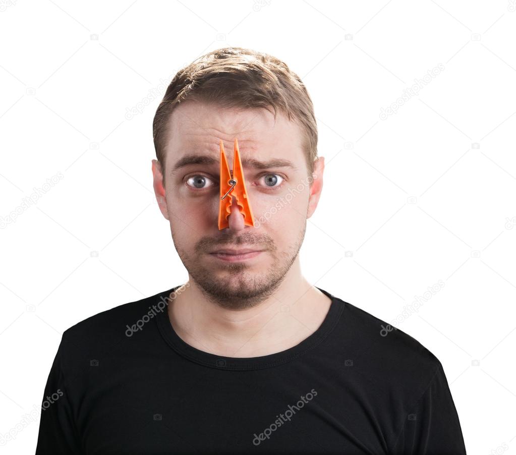 Man with clothespin on his nose.