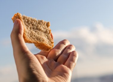 Hand hold a slice of bread. clipart