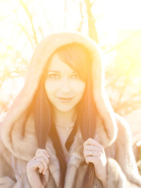 Winter girl with strong sunshine effect. Color toned image. — Stock Photo, Image