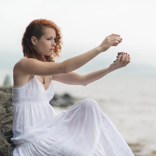 Woman holding zen stones in hand. — Stock Photo, Image