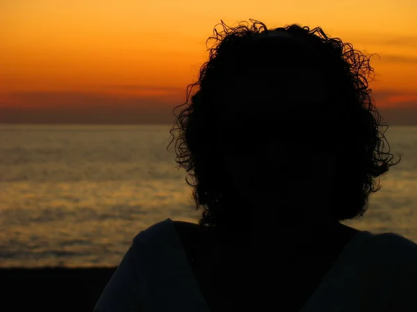 Female silhouette by the sea