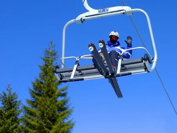 Skier on a ski lift Stock Photo