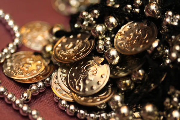 Close up of golden necklace on textile background — Stock Photo, Image