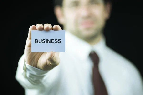 Empresário segurando um cartão — Fotografia de Stock