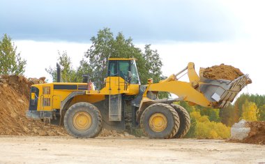 Heavy front loader in open pit
