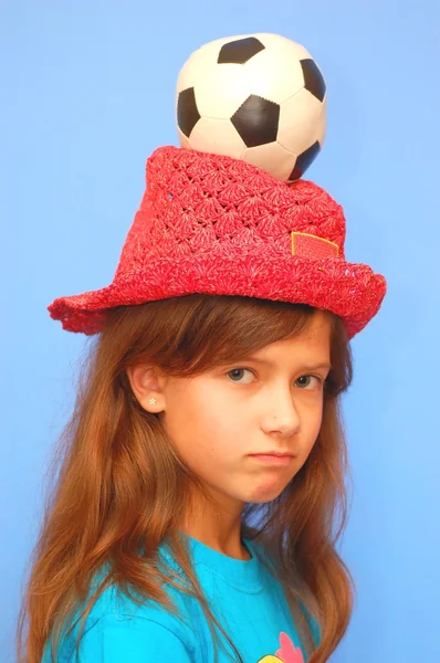 Teenage girl with soccer ball on her head — Stock Photo, Image