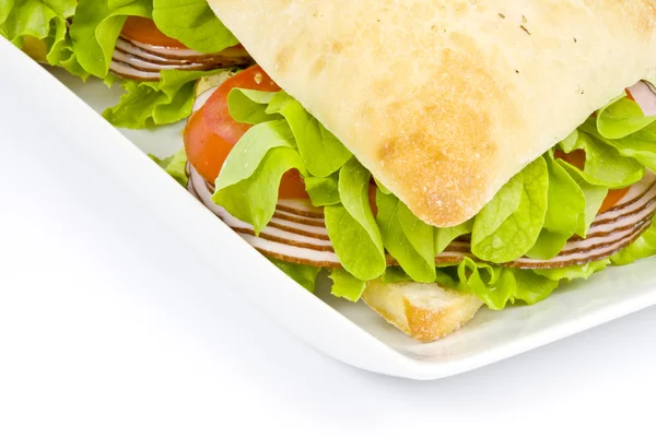 Focaccia sandwich på vit platta — Stockfoto