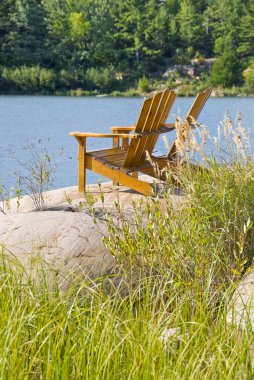 Muskoka, göl kenarında adirondack sandalyeler