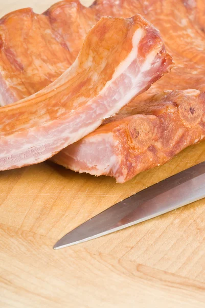 Rack mit geräucherter Schweinerippe auf einem Schneidebrett — Stockfoto