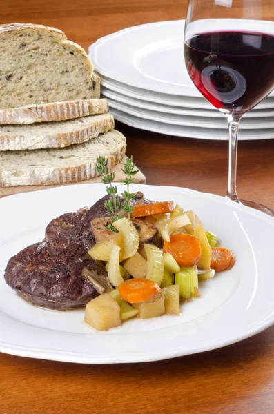 Hovězí dříku večeře s olivový chléb a červeným vínem — Stock fotografie