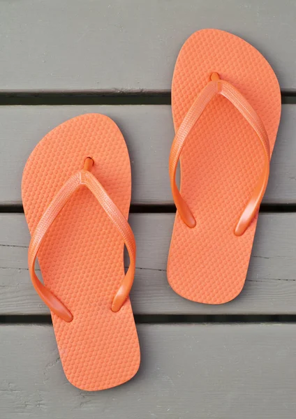 Orange Flip Flips auf dem Deck — Stockfoto