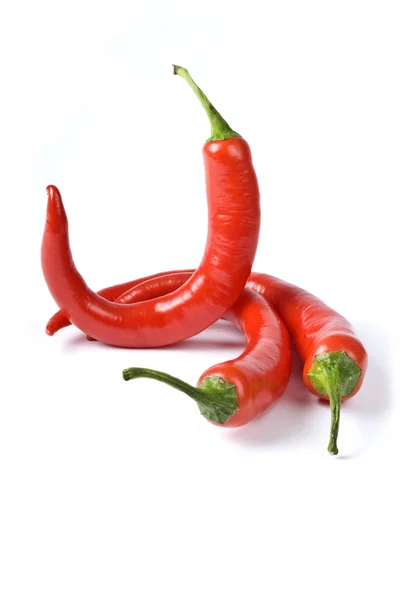 Three Hot Red Chili Peppers Isolated on white — Stock Photo, Image