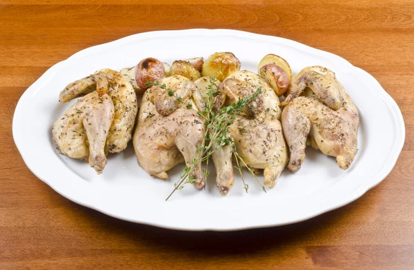 Roasted Cornish Game Hen and Potatoes Garnished with Sprig of Thyme — Stock Photo, Image