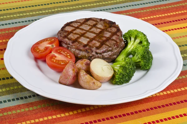 Grilovaný rib eye steak podávaný s brokolicí, brambory a rajčata — Stock fotografie