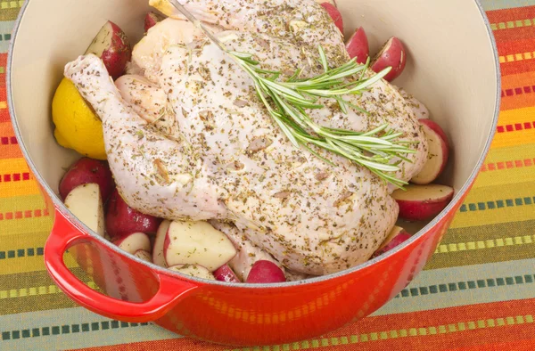 Raw Chicken with a Sprig of Rosemary in a Dutch Oven — Stock Photo, Image
