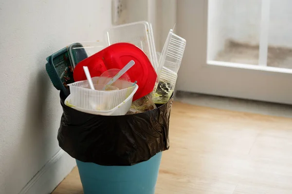 Disposable plastic food containers in the trash, Household plastic waste problem, recycle