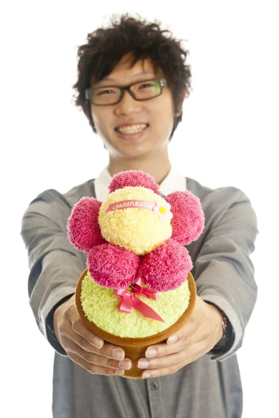 Smiling young man giving flower — Stock Photo, Image