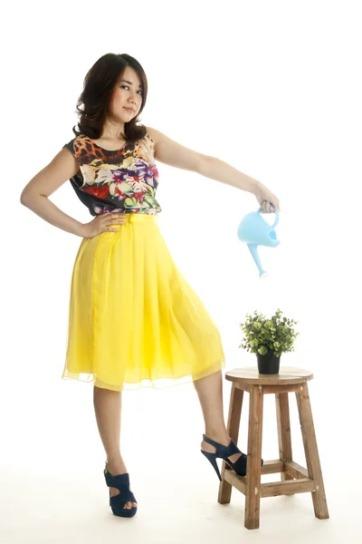 Attractive female with a watering can — Stock Photo, Image