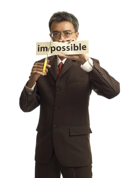 Asian businessman cut the paper for turning word impossible into — Stock Photo, Image