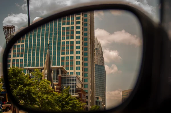 Buildings seen in side mirror — Stock Photo, Image