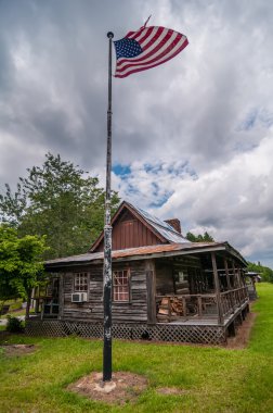old log cabin and american flag clipart