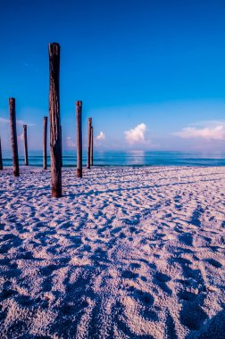 Old sea pier ruins on the beach