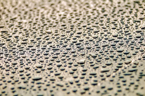 Gotas sobre la superficie repelente al agua —  Fotos de Stock