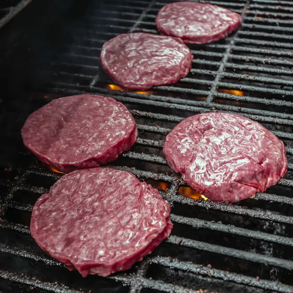 Tasty beef burgers on the grill — Stock Photo, Image