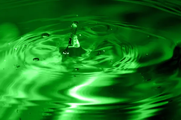 Green multi colored water drop bubbling — Stock Photo, Image