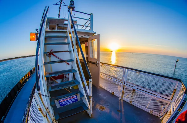 Riding on a ferry boat at sunset — Stock Photo, Image