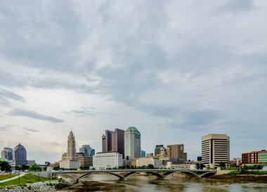 Columbus Ohio skyline and downtown streets in late afternoon clipart