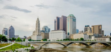 Columbus Ohio skyline and downtown streets in late afternoon clipart