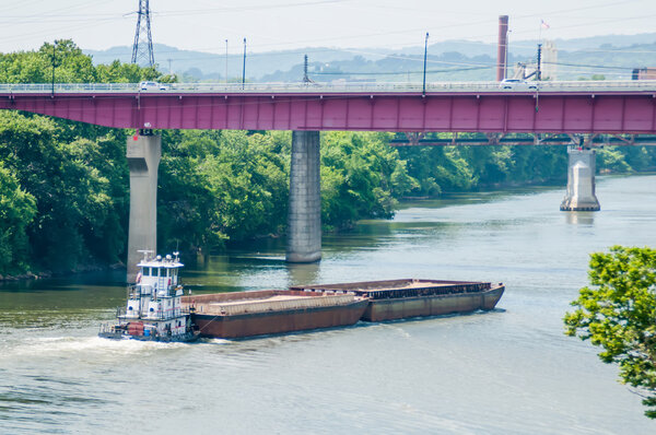 barge ship moving on water towards bridge