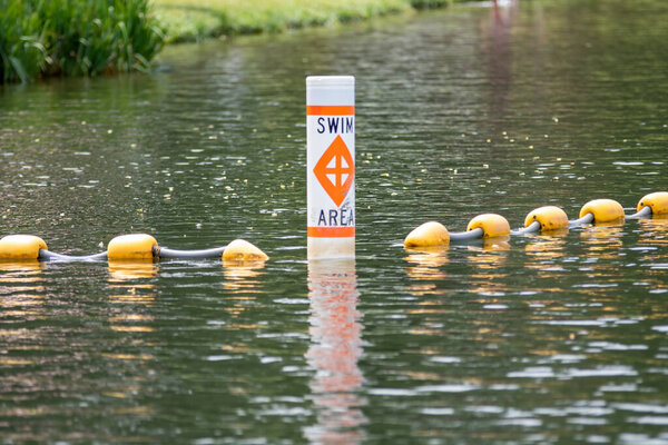 Swimming area border marked with red and orange floats