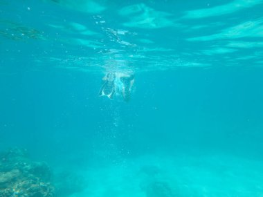 diver vanishing underwater in a distance