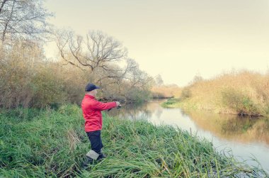 Balıkçı oltasını nehre atıyor. Sanny Day 'de balık avı. 