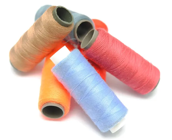 Heap of many-coloured bobbins of thread — Stock Photo, Image