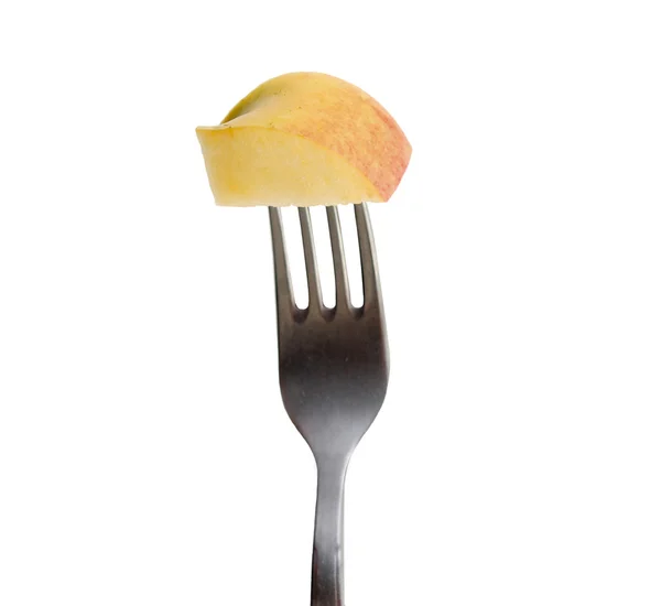 Slice of apple held by a fork — Stock Photo, Image