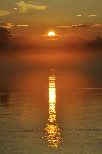 Tramonto sul fiume nella nebbia — Foto Stock