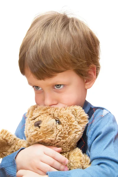 The offended boy with toy bear on white — Stock Photo, Image